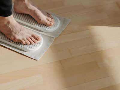 Close-up of a person's feet maintaining balance on the floor.